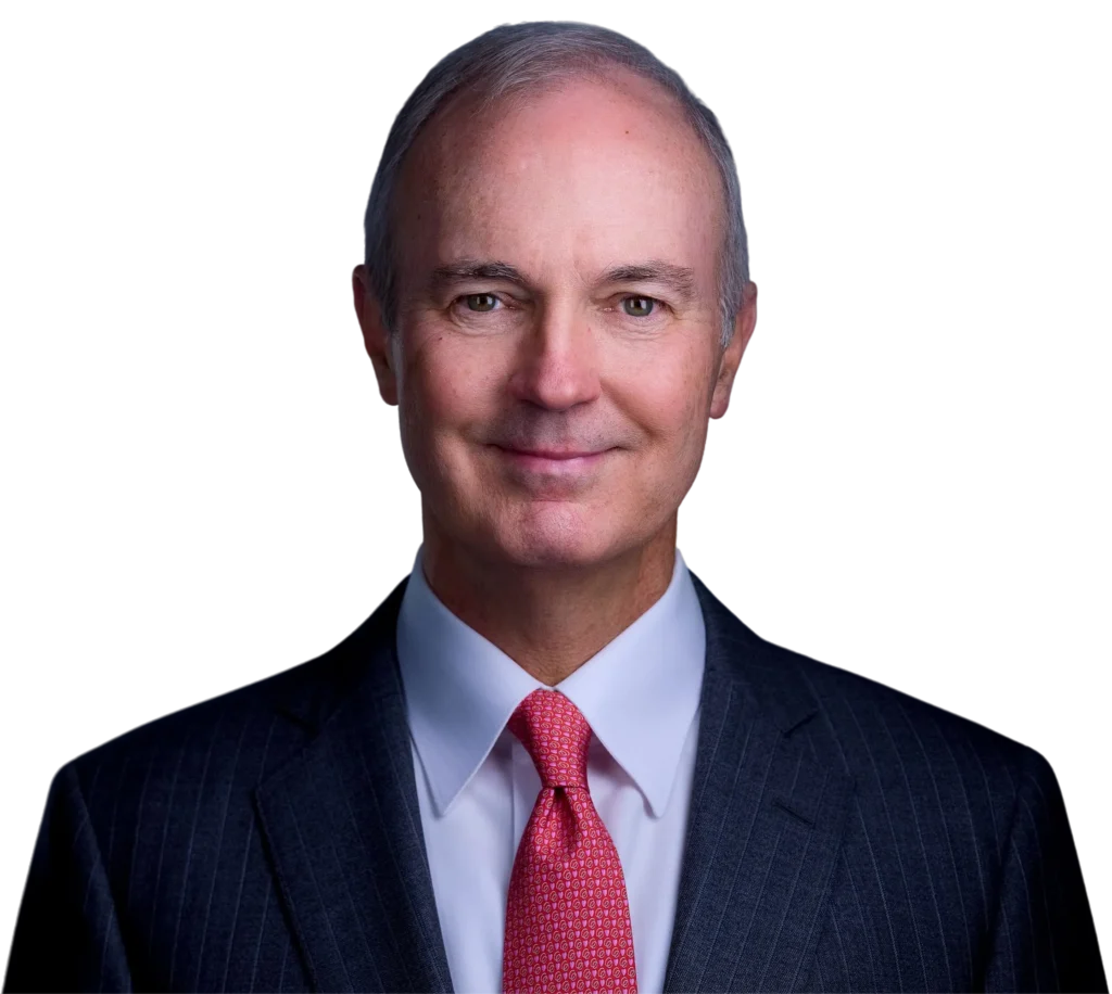 Professional headshot of a business executive wearing a suit and red tie, smiling confidently